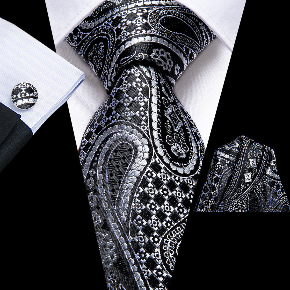 Black and silver paisley silk tie styled with matching pocket square and cufflink