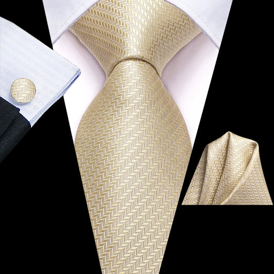 Champagne gold herringbone tie with matching pocket square and cufflink styled with navy suit