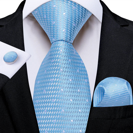 light blue silk tie with subtle polka dots styled with white shirt and black suit