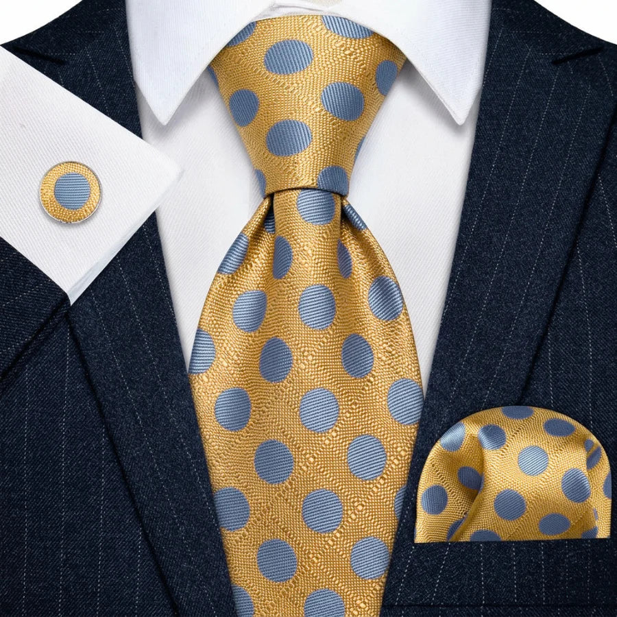 Gold and light blue polka dot tie set styled with matching pocket square and cufflink