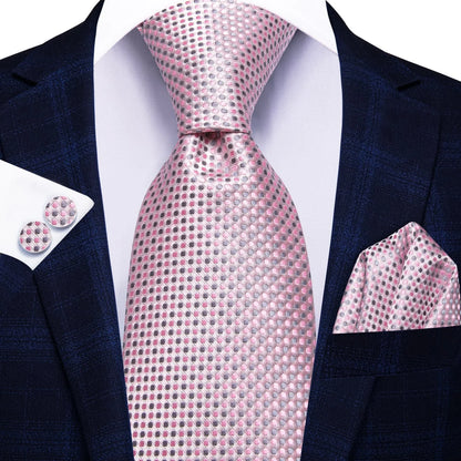 Pink and gray micro dot silk tie worn with navy suit, pocket square and cufflinks