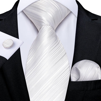 white textured striped silk tie worn with black suit pocket square and cufflinks