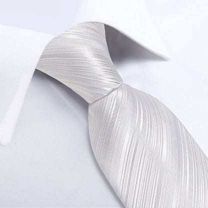 close-up of white textured striped silk tie under white dress shirt collar