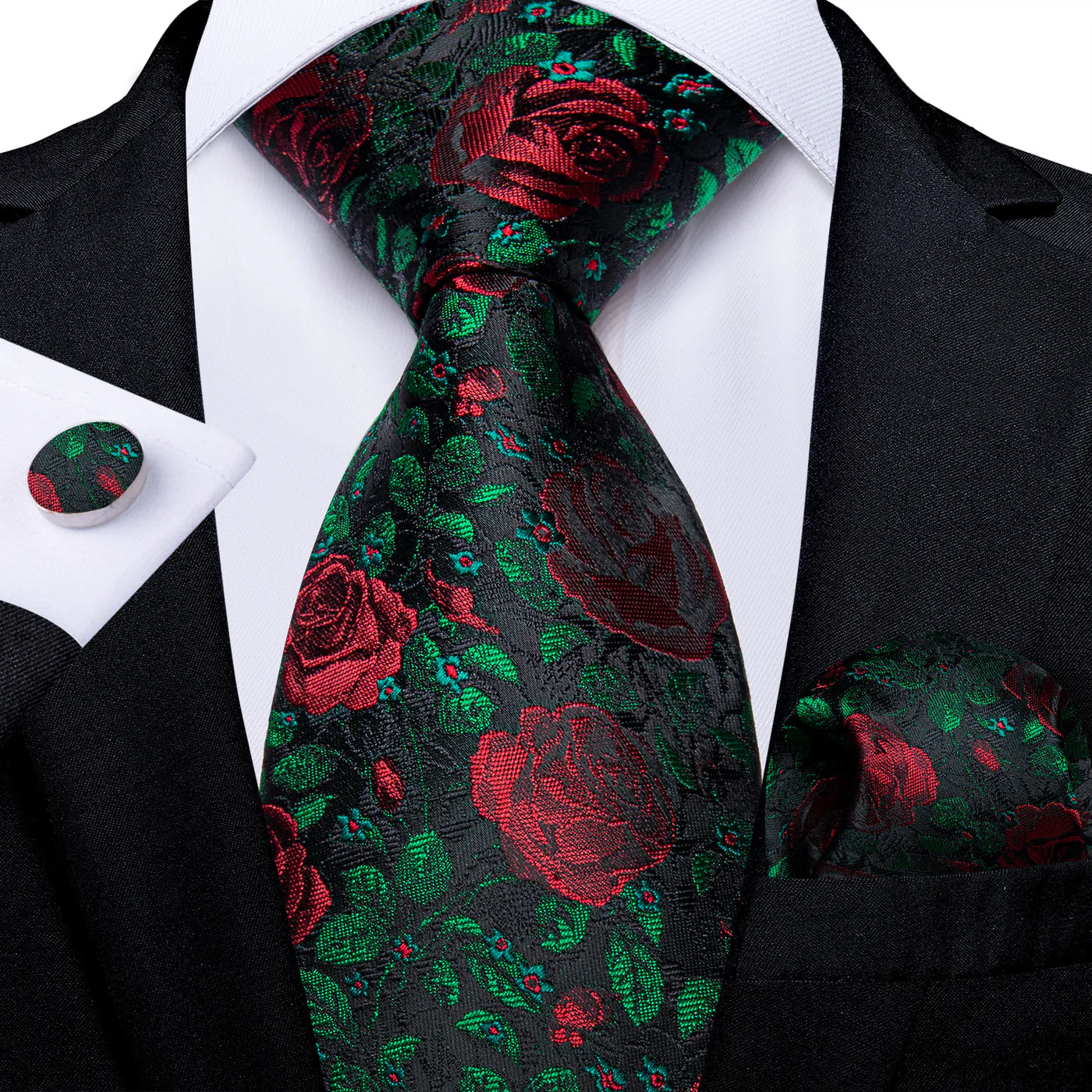 black silk tie with red rose floral pattern and green accents styled with suit pocket square cufflinks