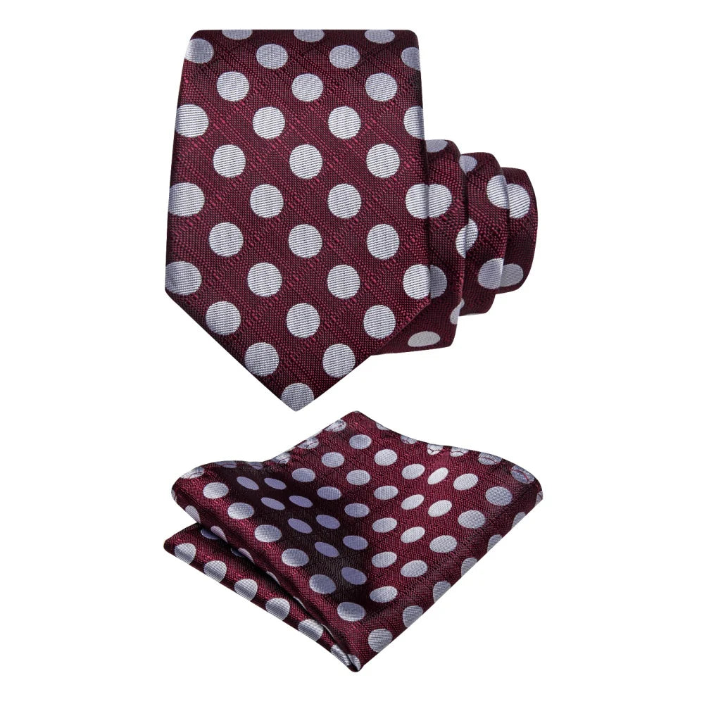 Burgundy polka dot silk tie with matching pocket square on white background