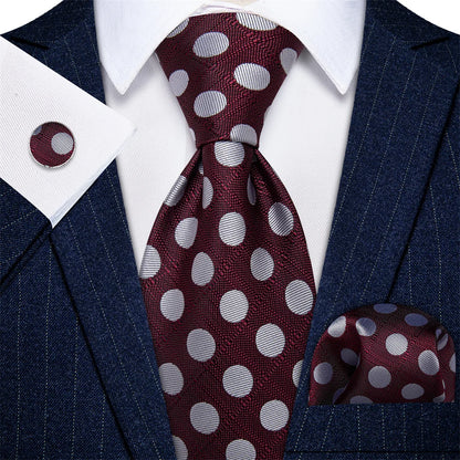 Burgundy polka dot silk tie set styled with matching pocket square and cufflinks