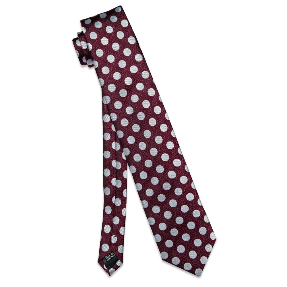 Burgundy polka dot silk tie displayed full length with silver dot pattern